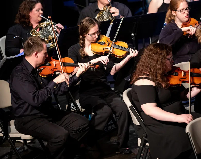 orchestra students performing on stage 