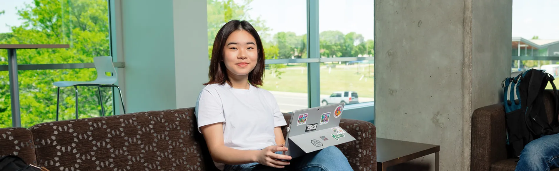 student on a laptop sitting on a couch