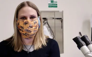 STEM student Melissa Sawyer pictured inside one of NHCC's labs with her mask on