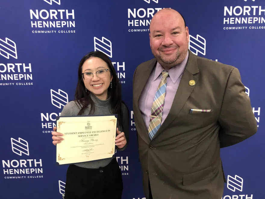 A photo of NHCC President, Dr. Garcia with a student award winner smiling