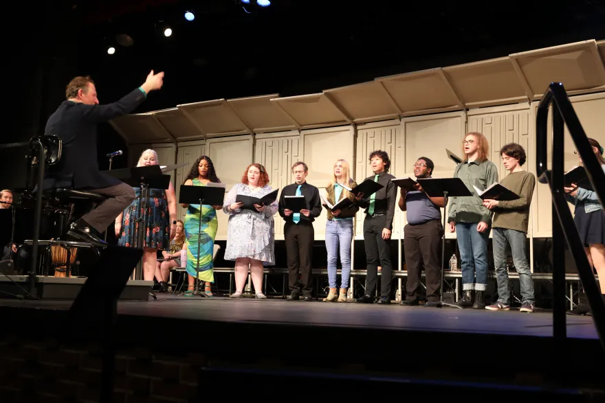 a photo of the NHCC choir singing on stage 