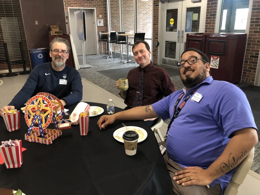 Staff and faculty sitting together in the Campus Center