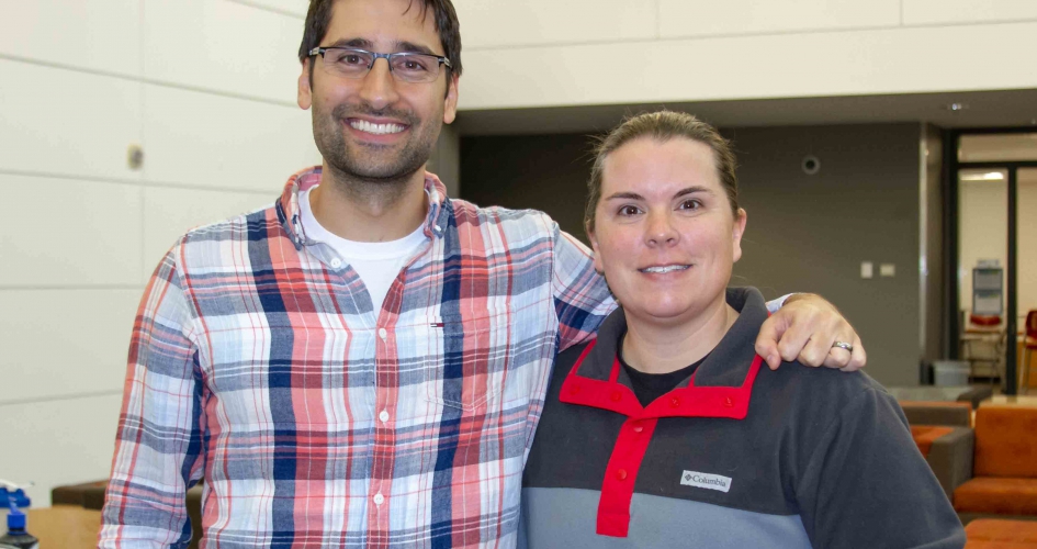 male and female faculty members smiling inside
