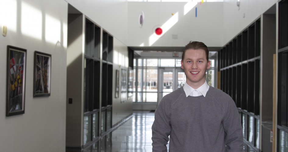 student Nathan standing in a hallway