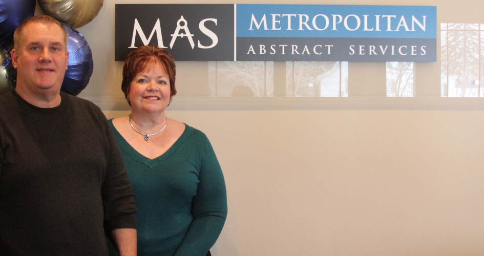 alumni couple Tom and Erika Solom standing proudly in front of their startup business