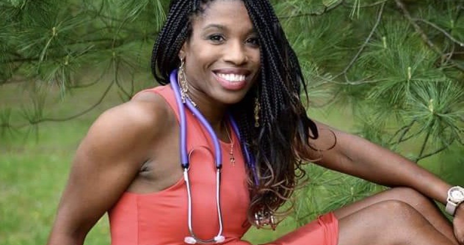 nursing alumni Jeanette Rupert posing for the camera outside below a pine tree