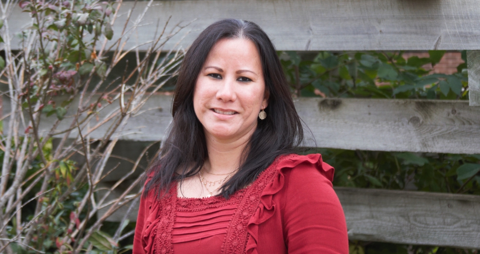 faculty member and veteran Janet Lorenzo standing outside smiling at the camera