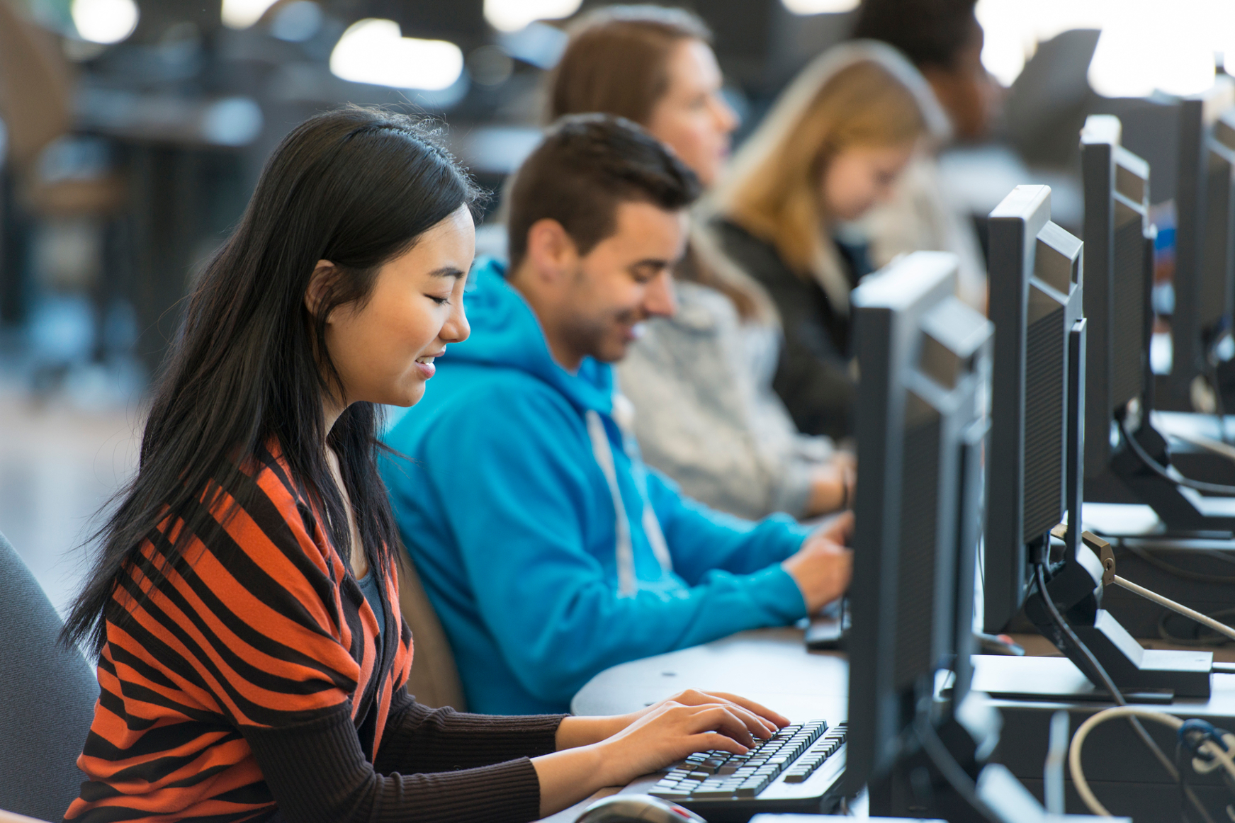 photo of students near a computer
