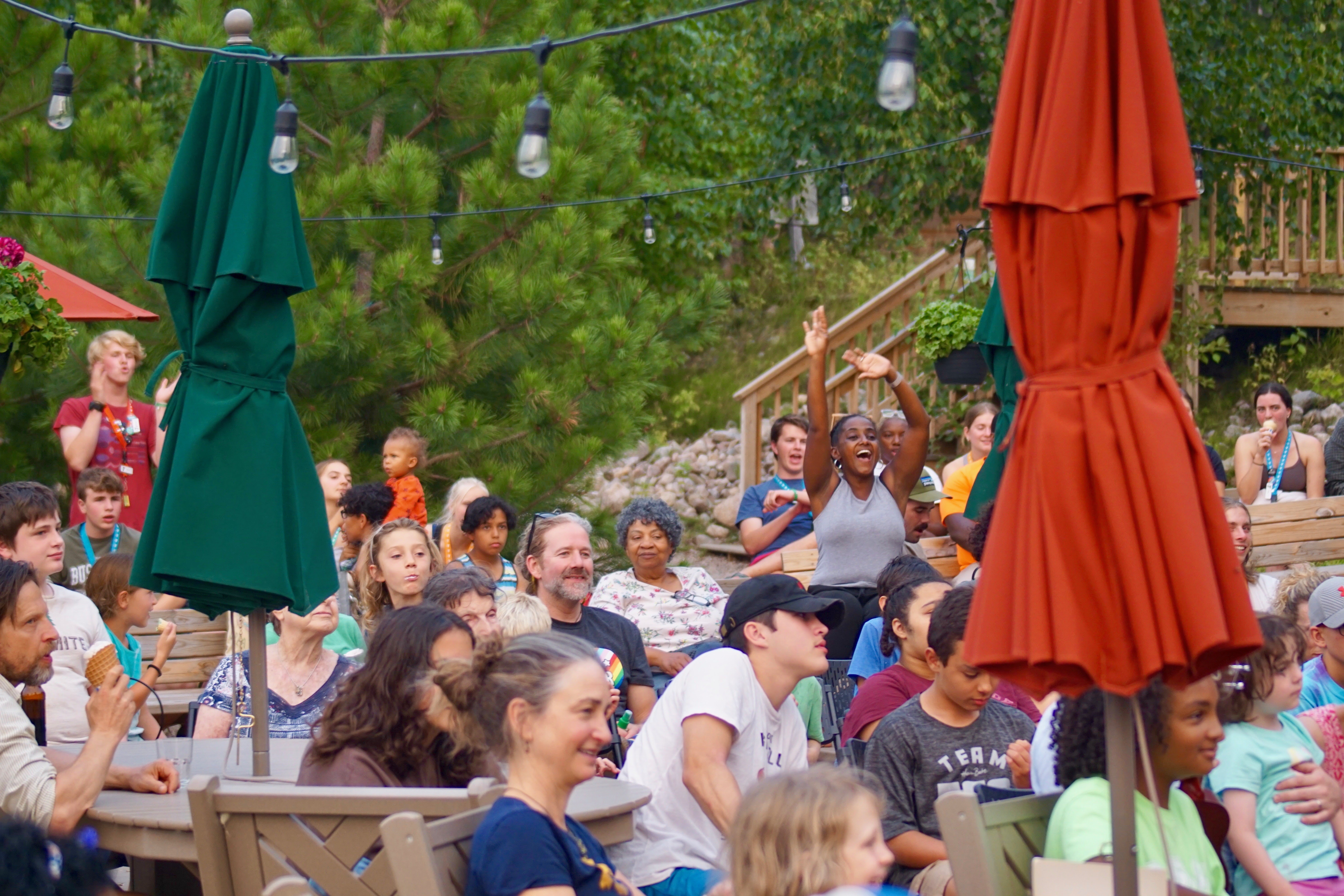 Photo of adults and young adults outside at summer camp