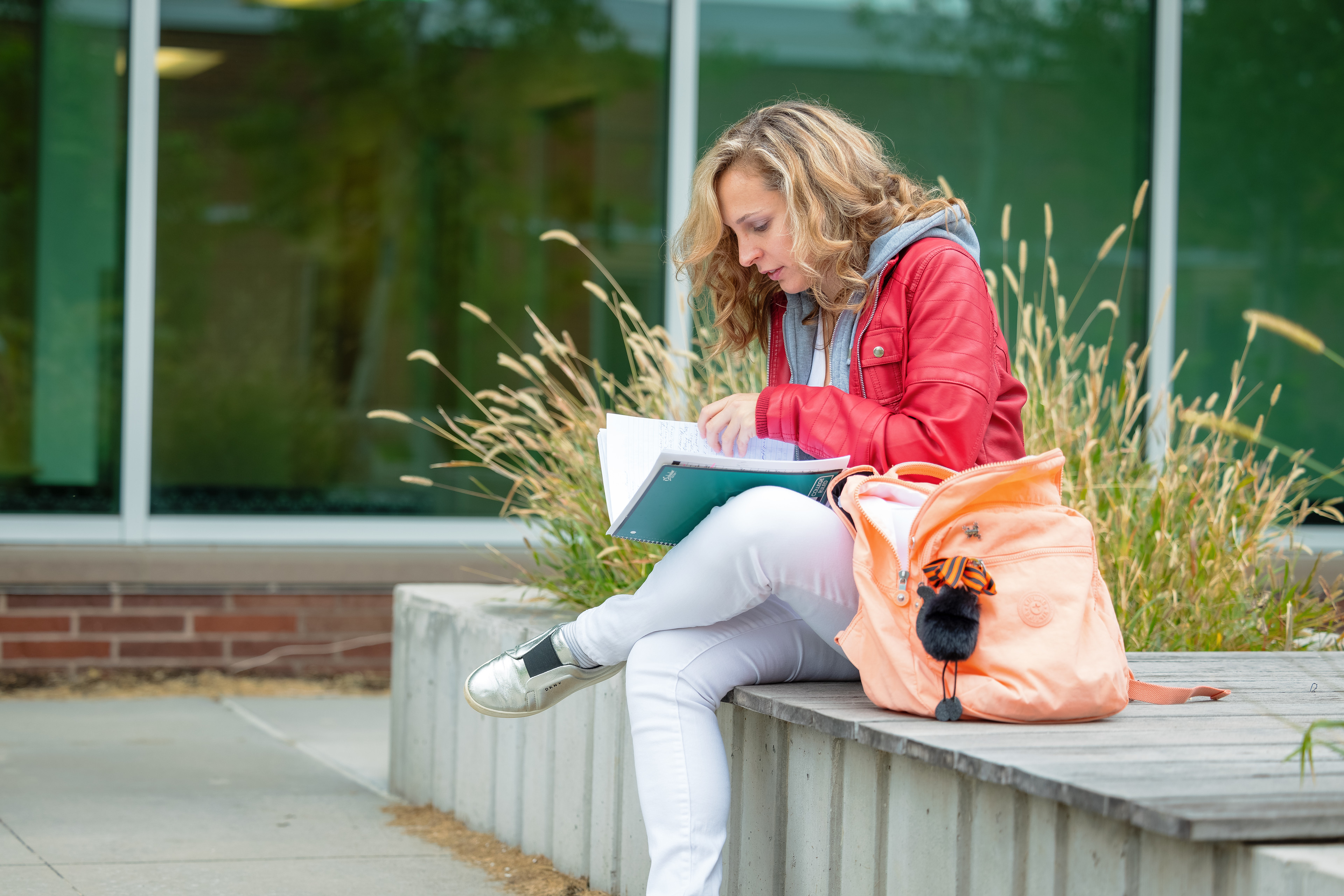 female, adult student studying outside