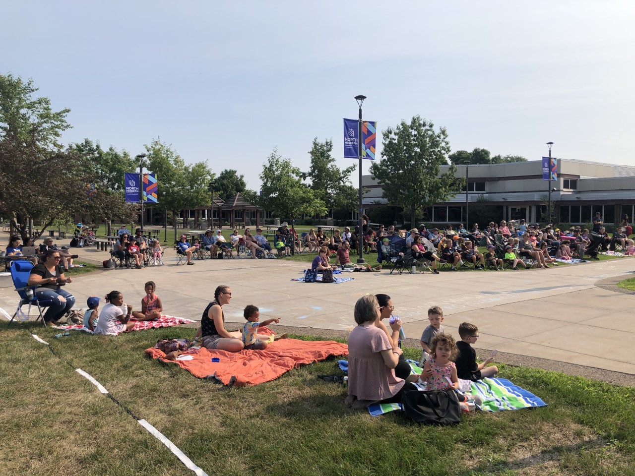 a photo of people in NHCC's courtyard during the summer