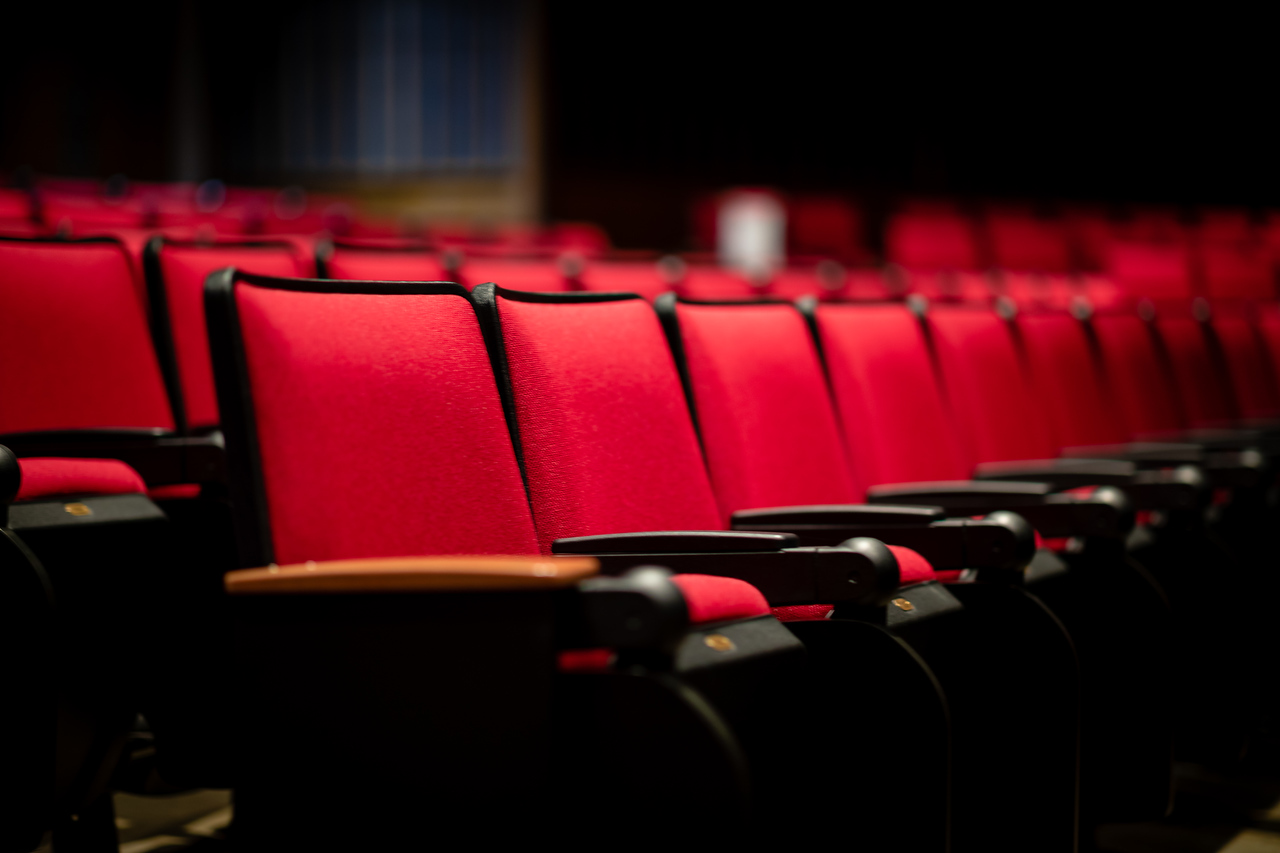 a row of red seats in a theater
