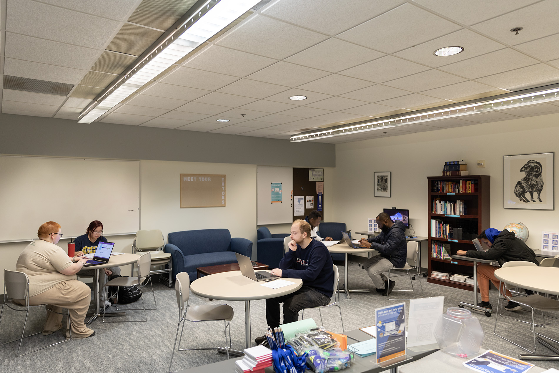 students on laptops in the writing center