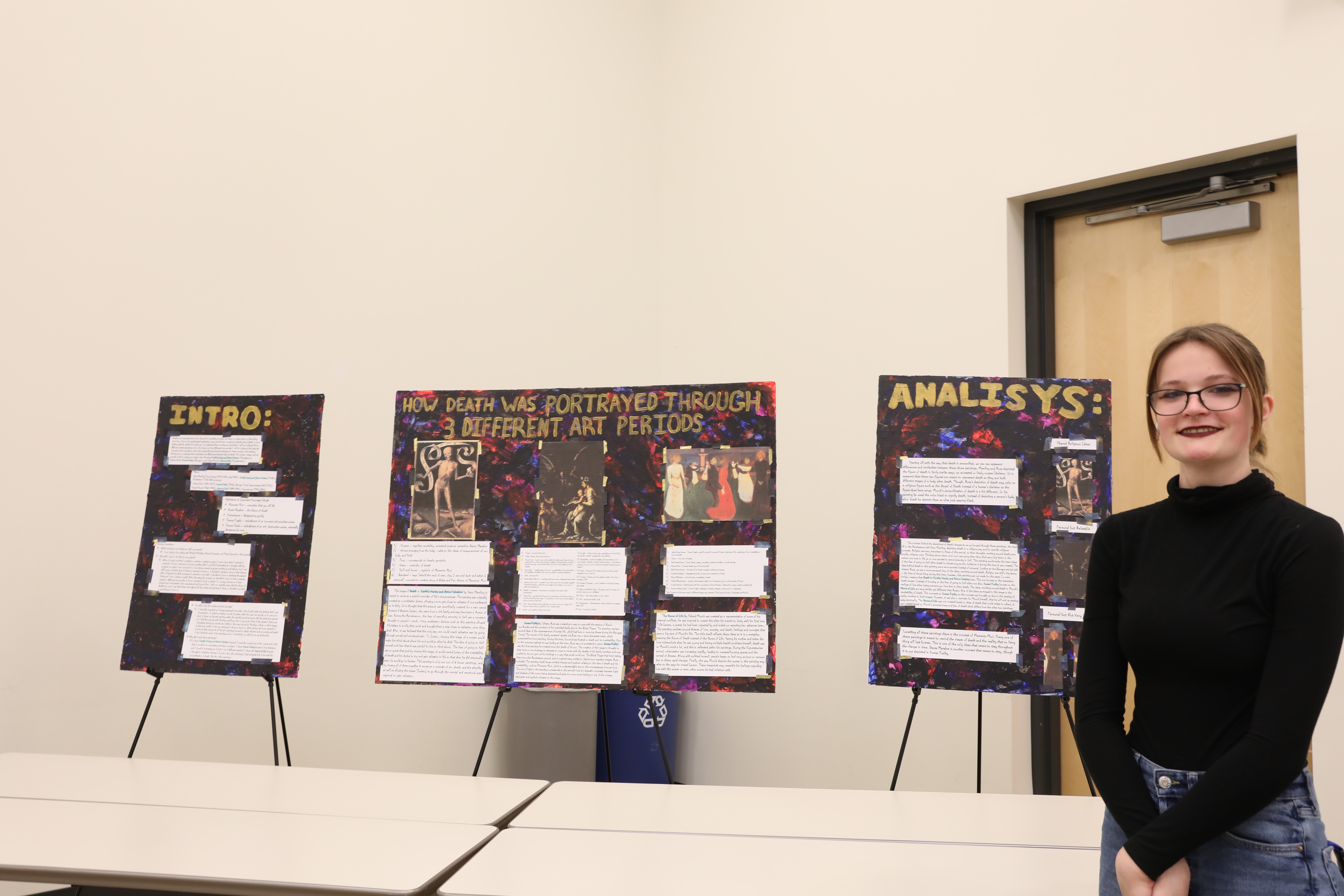 an NHCC art student with her research poster 