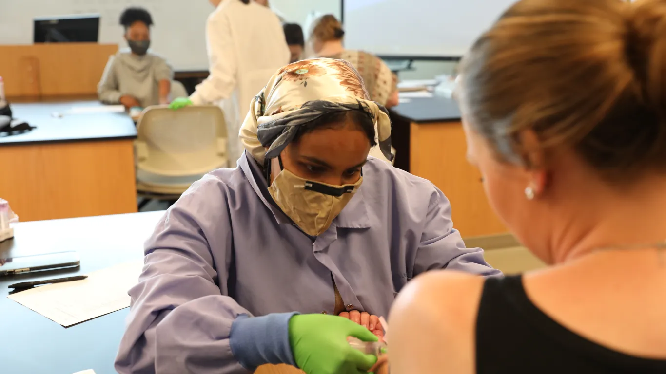 Phlebotomy student working in the lab