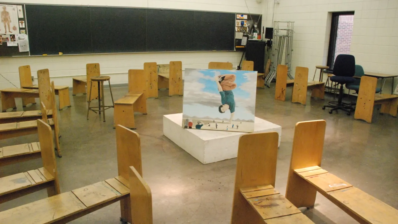 drawing benches in a art class with a drawing displayed in the center of the class