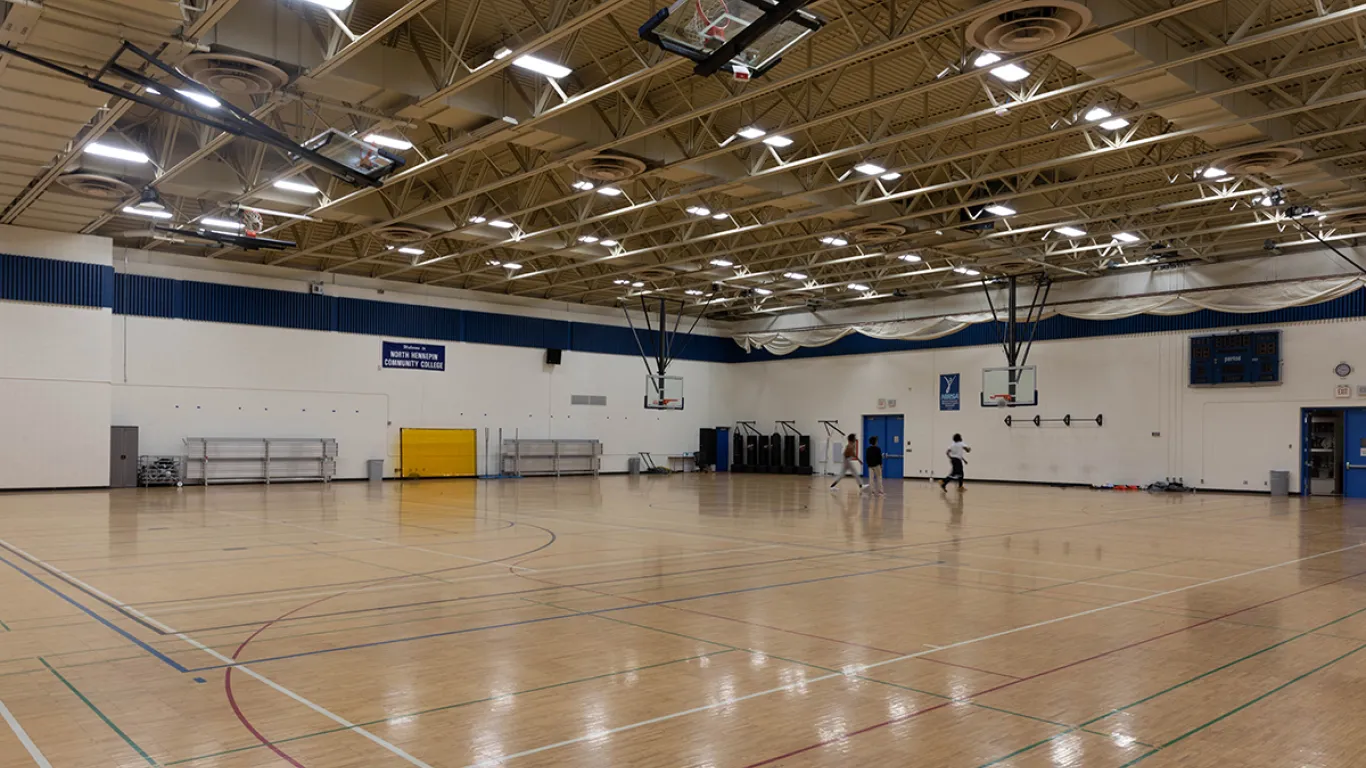 empty gym with wood floors and bright lights