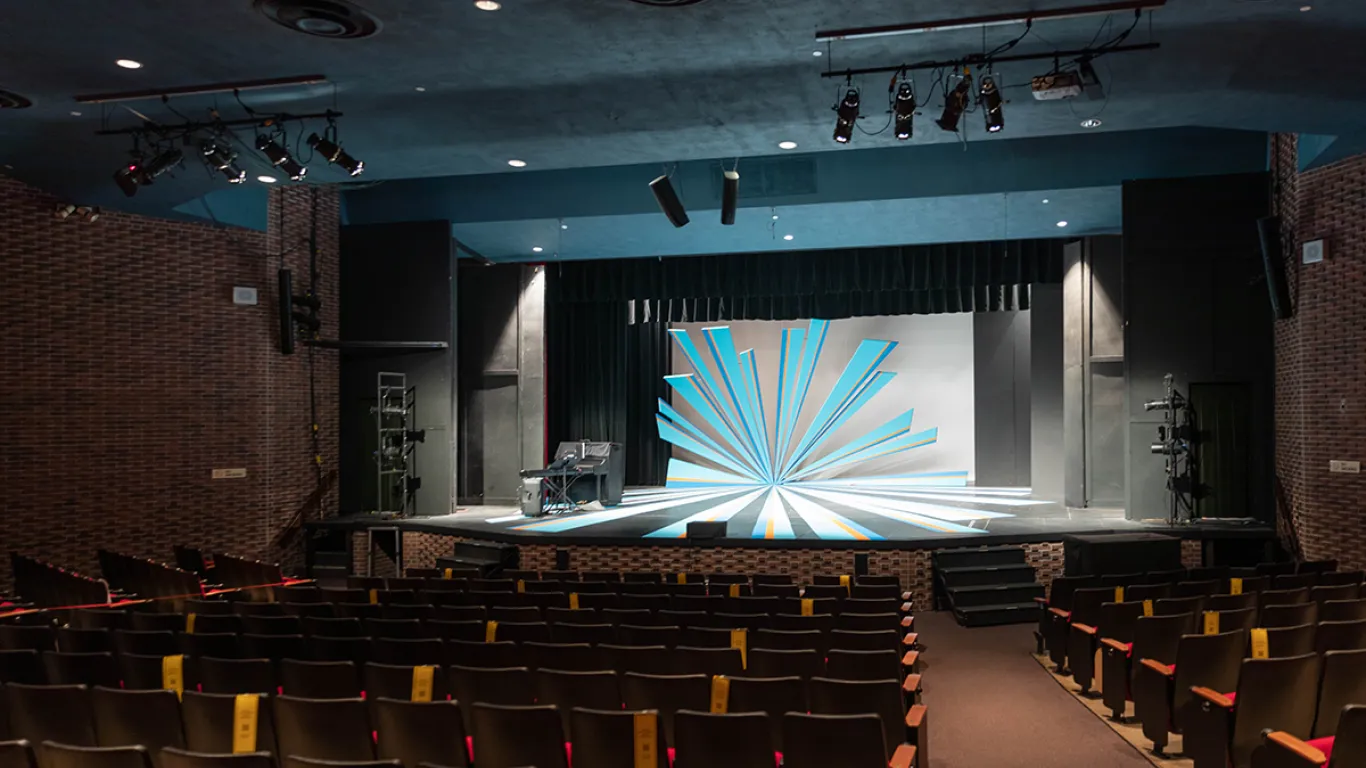 empty theater with seats and stage lighting