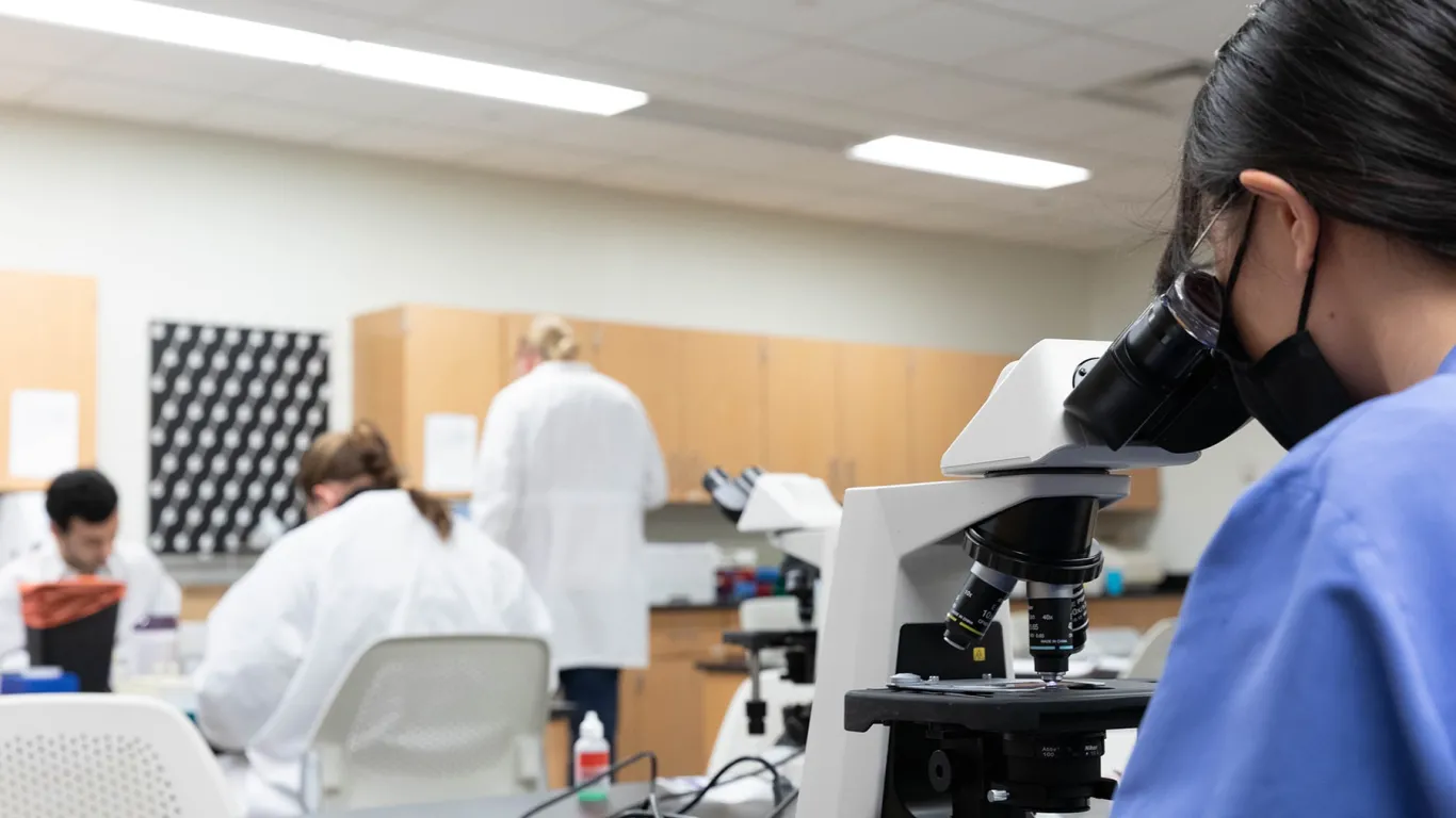 students working at a table in the medical lab technology lab 