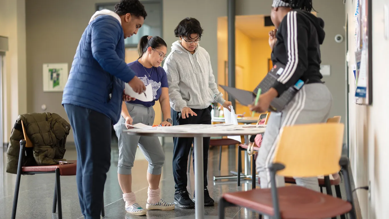 students talking around a table