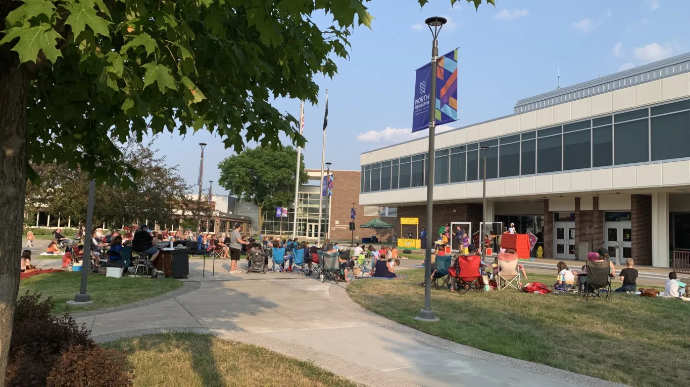 people sitting in chairs at a campus event 