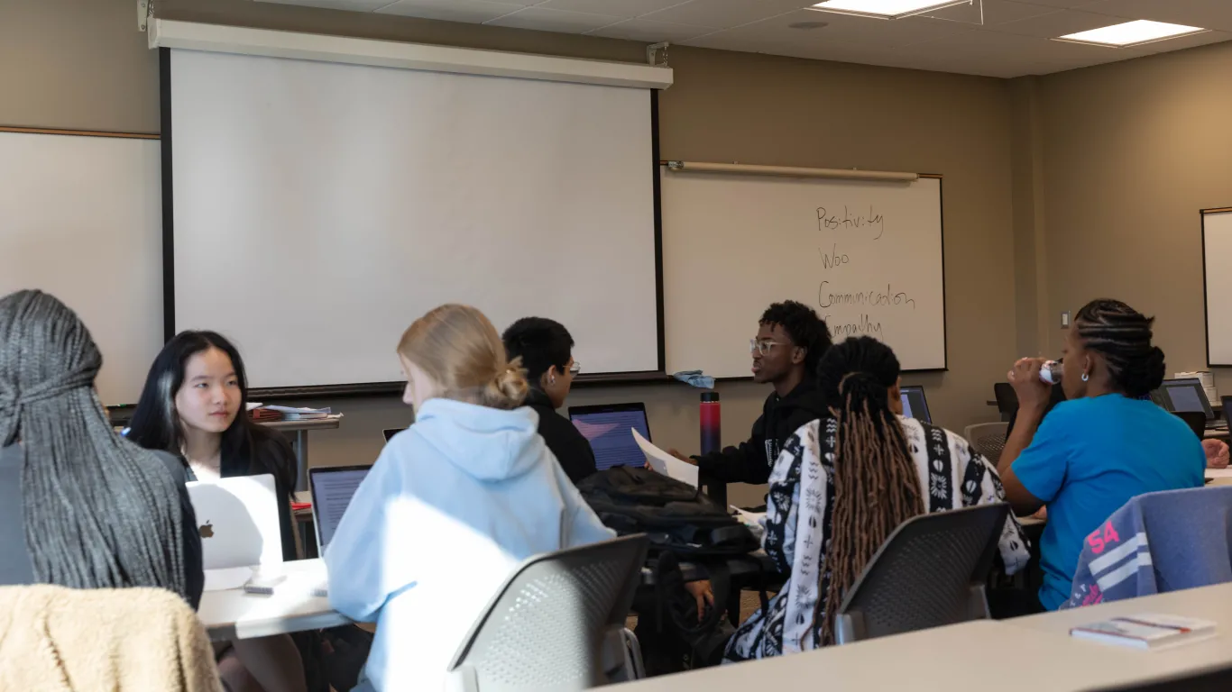 students working and talking in classroom 