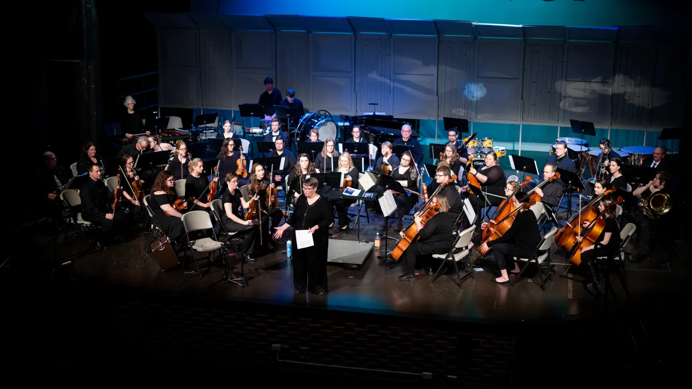 full orchestra performing on stage 