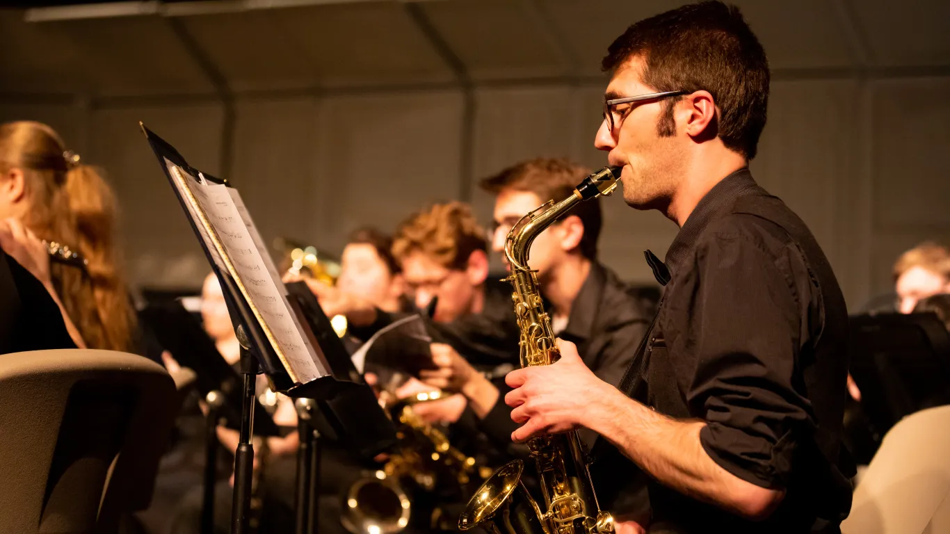 student playing a saxophone on stage