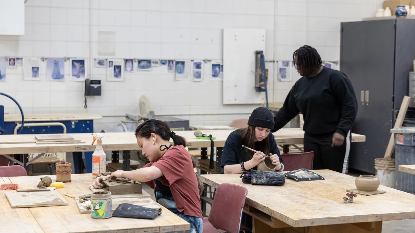 students doing ceramics at tables 