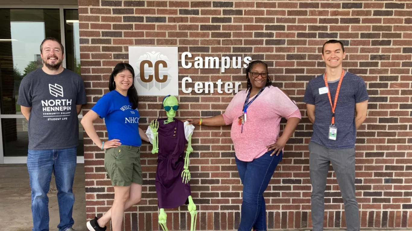 group of people and toy skeleton in front of Campus Center