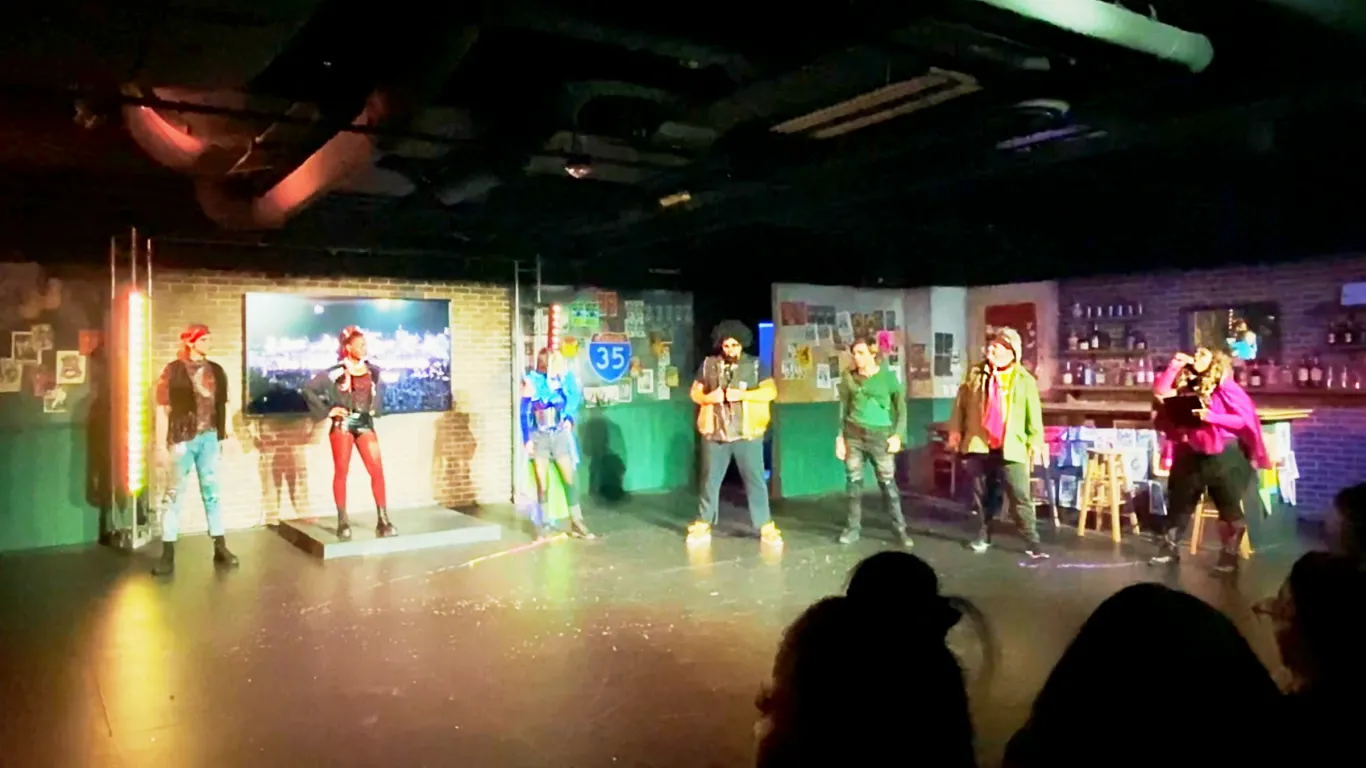Actors performing on stage in the play “Airness”