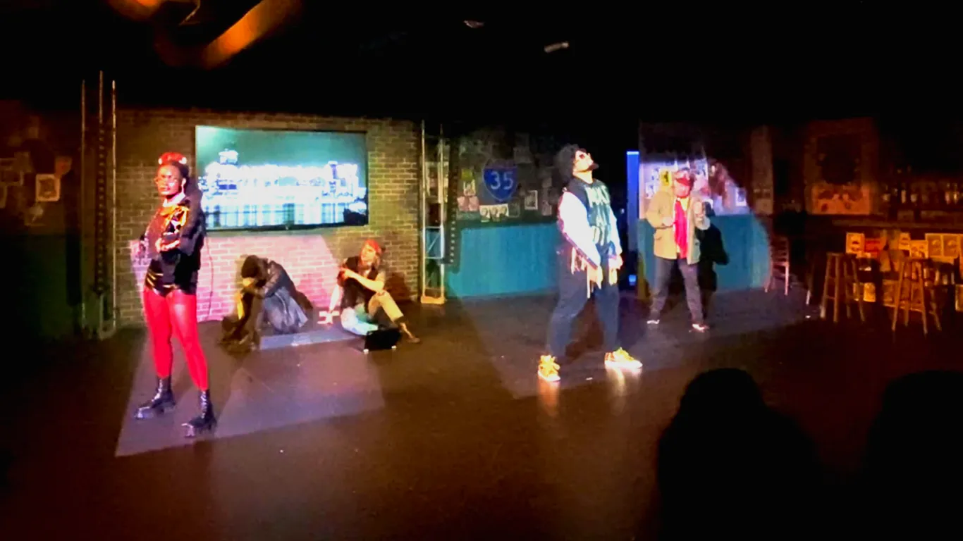 Actors performing on stage in the play “Airness”