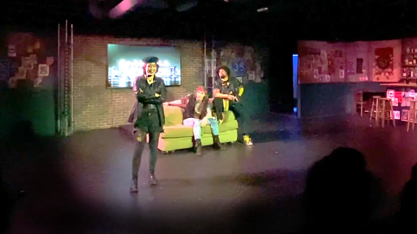 Actors performing on stage in the play “Airness”