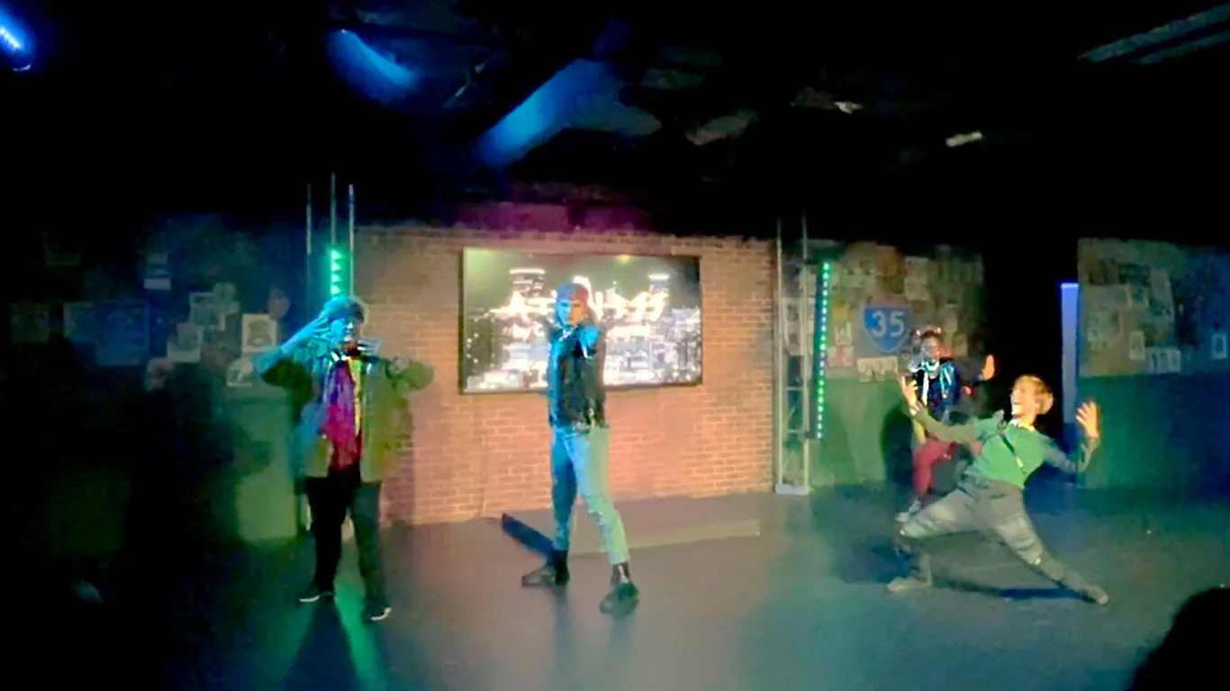 Actors performing on stage in the play “Airness”