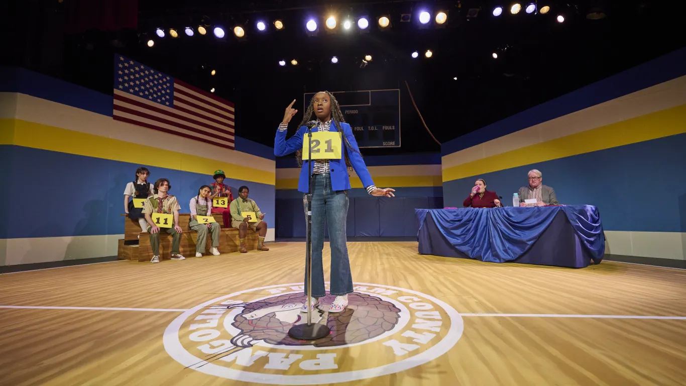 An actor performing on stage in the musical “The 25th Annual Putnam County Spelling Bee”