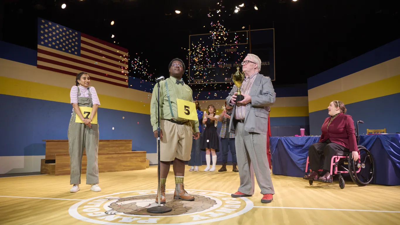 An actor performing on stage in the musical “The 25th Annual Putnam County Spelling Bee”