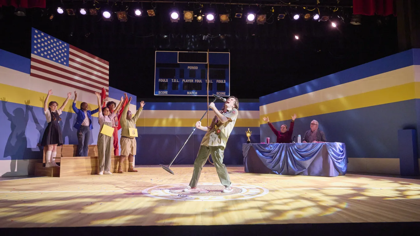 An actor performing on stage in the musical “The 25th Annual Putnam County Spelling Bee”
