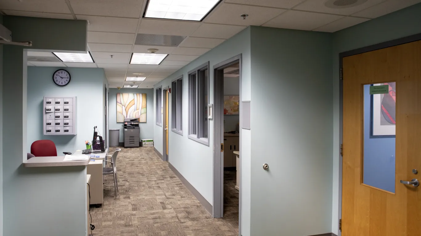 hallway with doors and a welcome desk