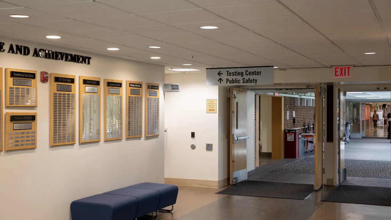 hallway with sign over a door that reads testing center