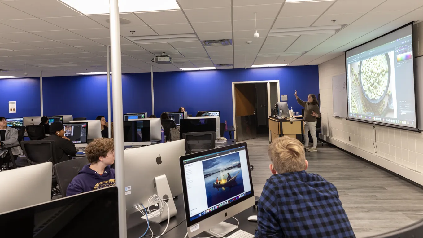 student at a computer looking at an instructor 