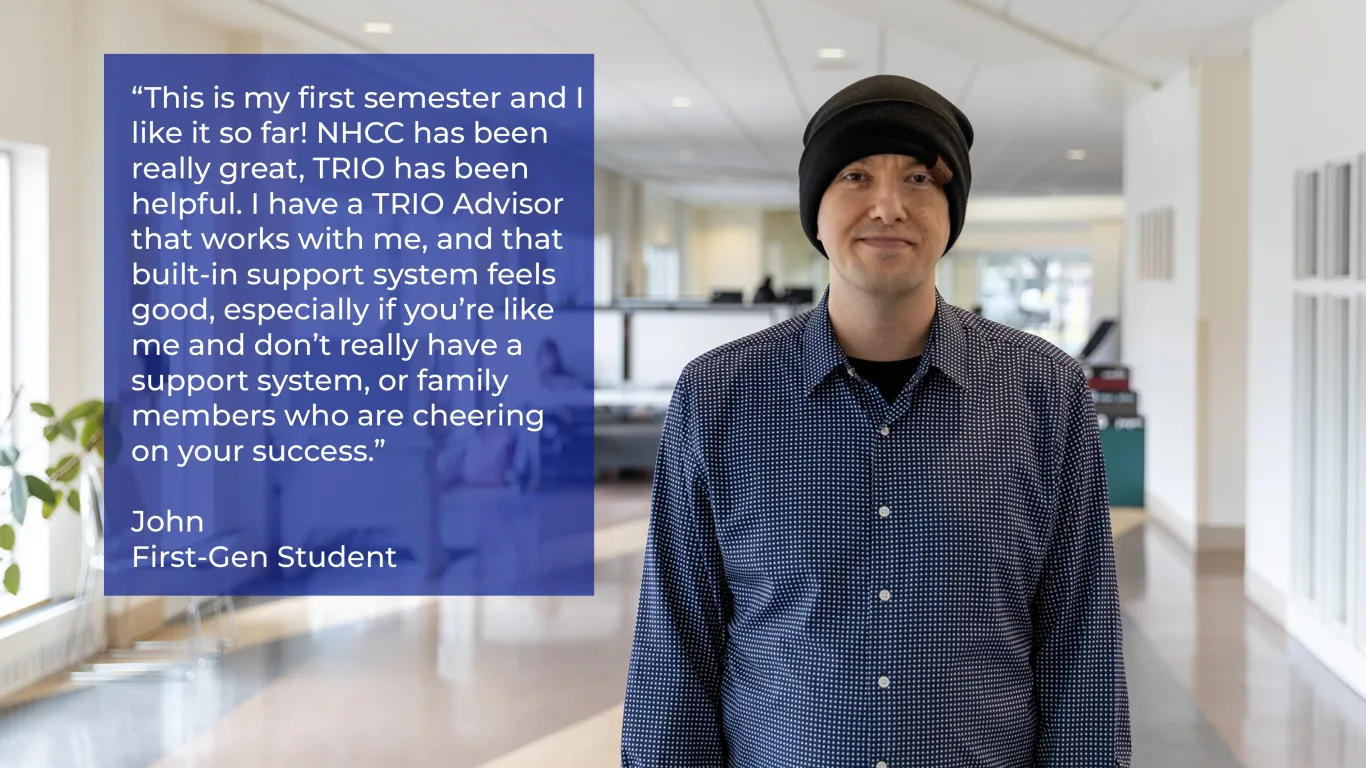 student smiling in a hallway wearing a hat