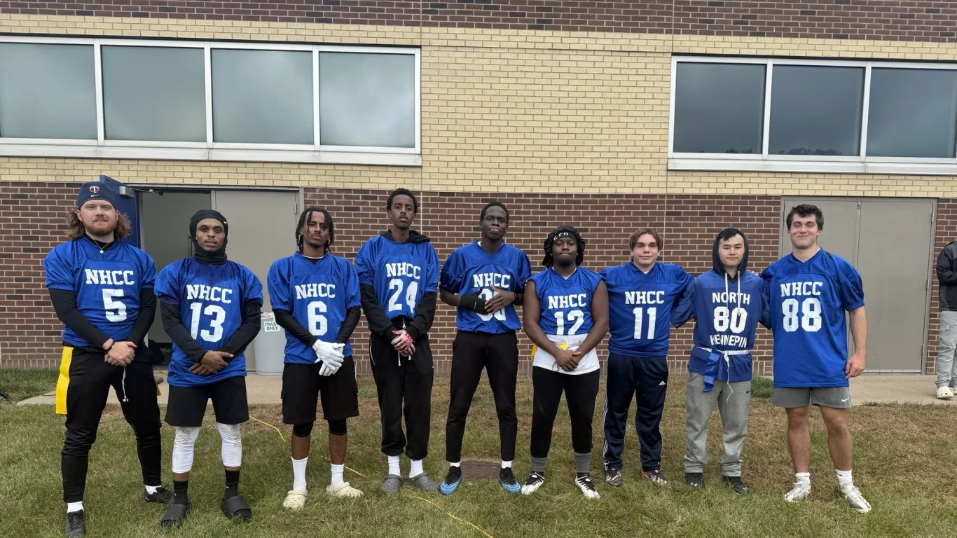 Team posing in front of a building