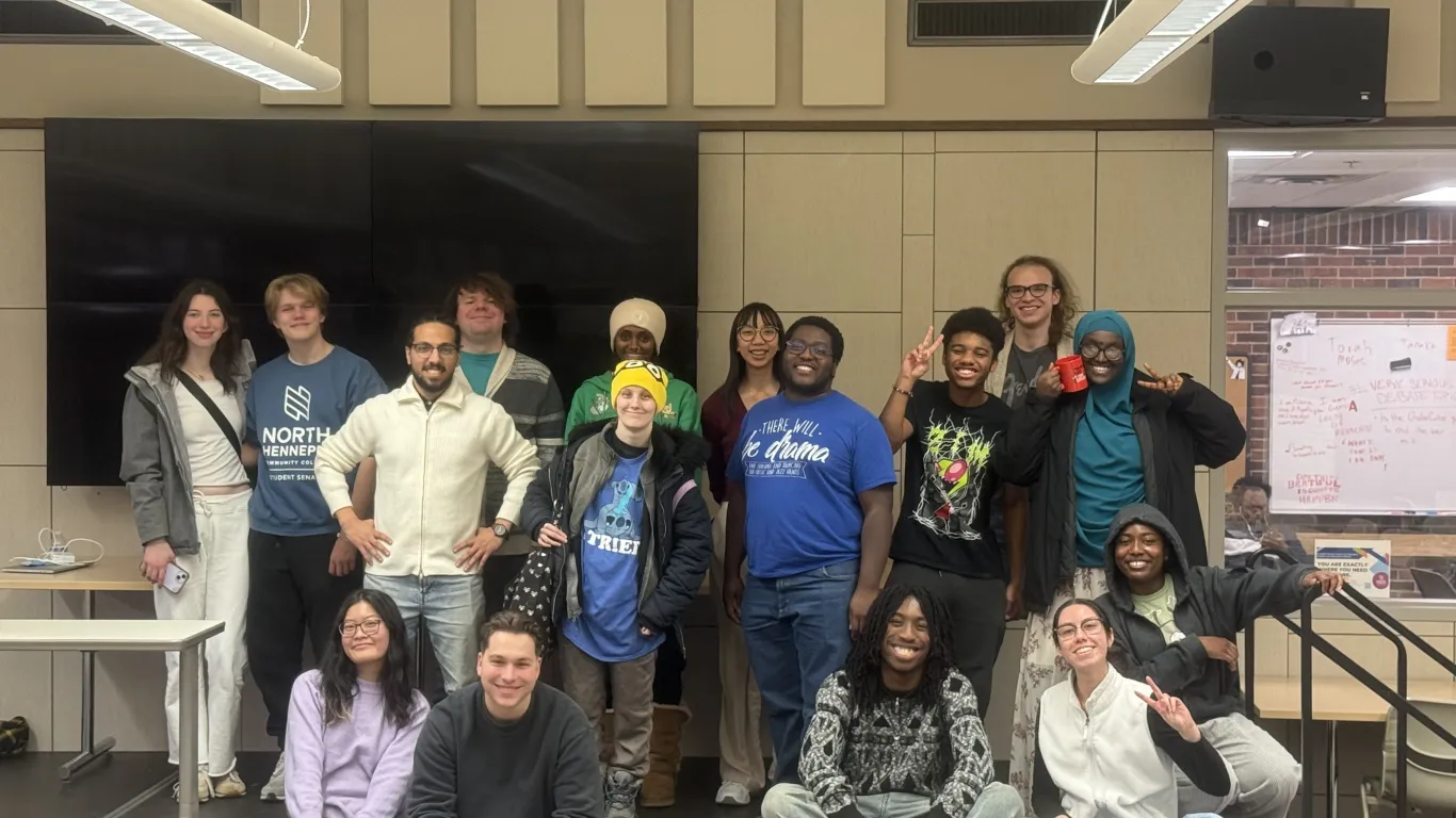 Group of students smiling on a stage