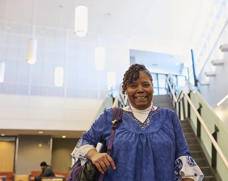 woman smiling with a staircase in the background 