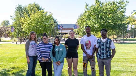 students standing outside smiling on a nice day