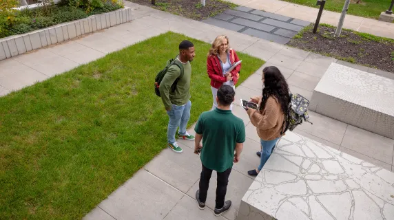 group of four student talking with each other outside