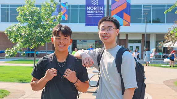 two students outside smiling on a nice day