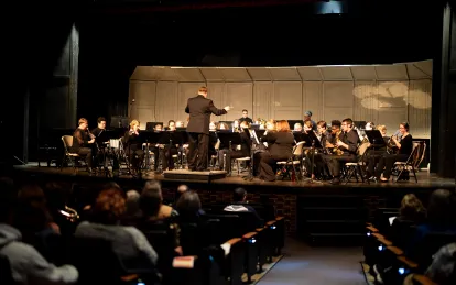 students playing in an orchestra on stage 