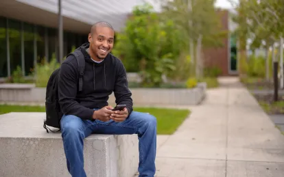 male student outside in the fall 