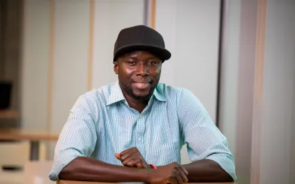 student smiling wearing a hat